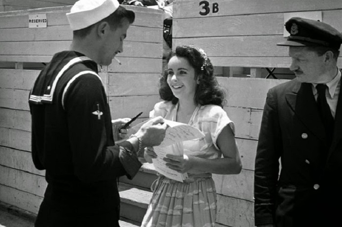 13-тилетняя Элизабет Тейлор раздает автографы во время благотворительного матча в крикет в Лос-Анджелесе. 13-тилетняя Элизабет Тейлор раздает автографы во время благотворительного матча в крикет в Лос-Анджелесе.