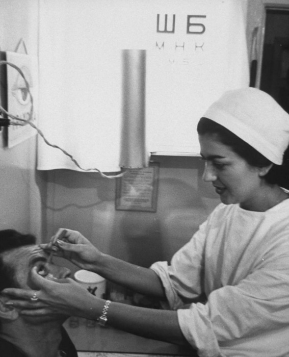 Врач закапывает капли в глаза работнику нефтепромыслов. Врач закапывает капли в глаза работнику нефтепромыслов.