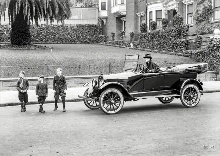 Дети переходят улицу перед остановившимся автомобилем в 1920 году. Дети переходят улицу перед остановившимся автомобилем в 1920 году.